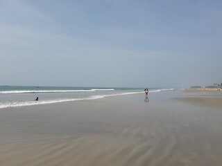 people walking on the beach, Indian Ocean beautiful beach in the goa, Arabian sea beach in goa,  blue water and sunny day. 