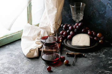 Glass of red wine served with cheese