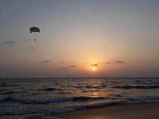 Parasailing in Goa at sunset. sunset over the sea. sunset at the beach. Goa beach. 