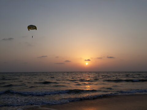 Parasailing in Goa at sunset. sunset over the sea. sunset at the beach. Goa beach. 