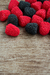 Sweet blackberrie red and black rubbers on a wooden surface   