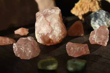 A image of several rough pieces of rose quartz arranged in a grid bathed in soft evening light.