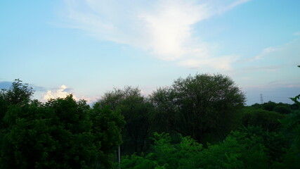 Horizon colorful sunset sight. Golden hovering clouds in the sky, red sunset rays,evening panorama, beautiful colorful rays view.
