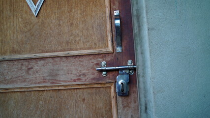 Traditional old Kitchen enter gate in Indian house with stainless steel handle. Made by wooden textures and ply-board.

