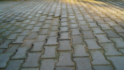Selective focus on Pedestrian path made with Cement blocks. Modern sidewalk pavement. Basic infrastructure concept.
