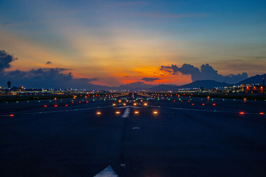 Airfield ground lighting on runway, sunrise time at Hong Kong Airport