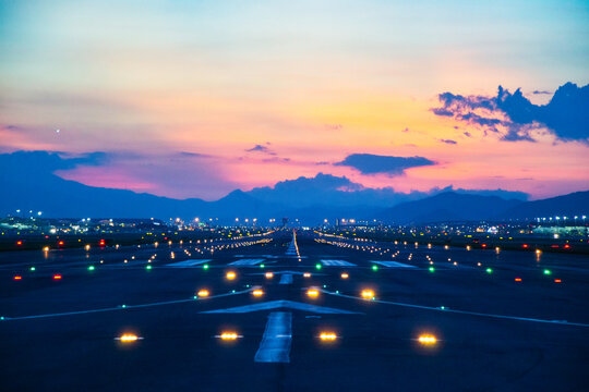 Airfield ground lighting on runway, sunrise time at Hong Kong Airport