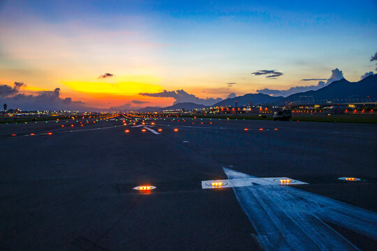 Airfield ground lighting on runway, sunrise time at Hong Kong Airport