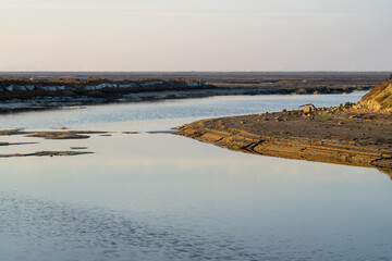 Wooden fence on a field / Sunset on the beach / sunset over the river