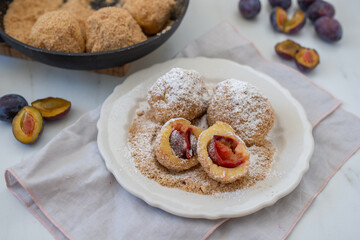 Typical Austrian plum dumplings made of leavened dough and fresh plums