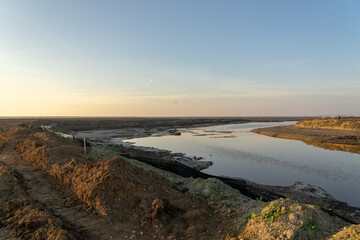 Wooden fence on a field / Sunset on the beach / sunset over the river