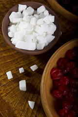 Candied coconut fruits in a clay bowl