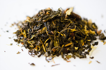 Green tea with additives closeup on white background. Proper nutrition, healthy tonic drink.