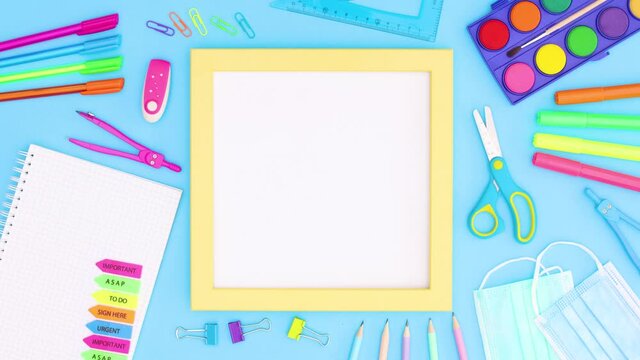 School stationery moving around yellow frame for text. Back to school stop motion 