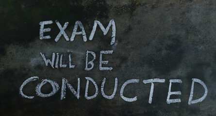 Exam Will Be Conducted Phrase Written on Blackboard with Chalk
