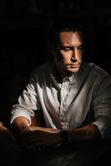 Fototapeta premium young attractive man looking and thinking. portrait of handsome man sitting in cafe