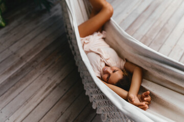 Blurred Young beautiful woman relaxing in hammock in a tropical resort