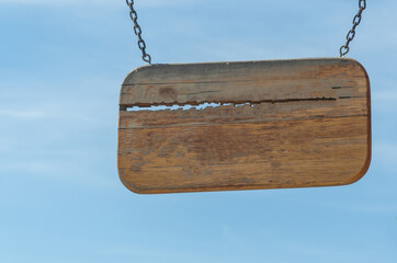 wooden plaque made of wood against the sky. copy space.