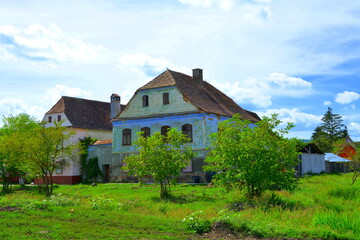 Fototapeta na wymiar Typical rural landscape and peasant houses in Beia, Transylvania, Romania. The settlement was founded by the Saxon colonists in the middle of the 12th century