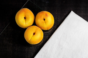 peaches on black background, dark food