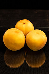 peaches on black background, dark food