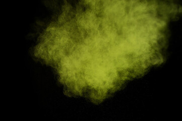 Light green powder explosion on black background. Colored powder cloud. Colorful dust explode. Paint  Holi.