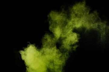Light green powder explosion on black background. Colored powder cloud. Colorful dust explode....