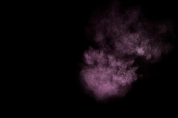 Purple powder explosion on black background. Colored powder cloud. Colorful dust explode. Paint Holi.