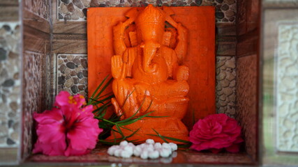 Famous Hindu god lord Ganesha, in a marble temple. Beautiful red idol. Ganesha Chaturathi special.