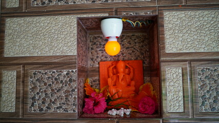 Famous Hindu god lord Ganesha, in a marble temple. Beautiful red idol. Ganesha Chaturathi special.