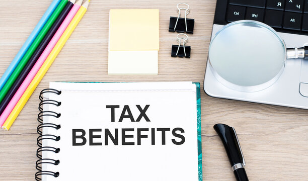 Text Tax Benefits On Notebook On Desktop
