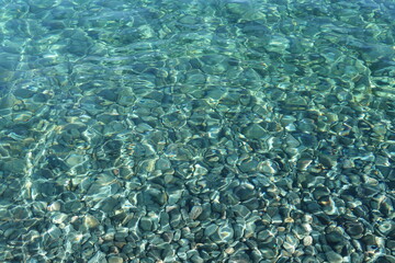 crystal clear turquoise blue water. azure coast.  stone under crystal water