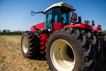 Red tractor on a agricultural field