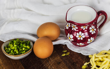 scrambled eggs ingredients on kitchen wooden table