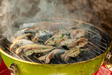 Grilling fish - sardines - ambient light only
