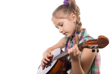 Cute little girl playing on domra. Studio photo.