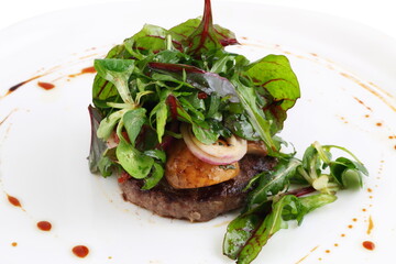 Meat steak with greens and mushrooms on white background
