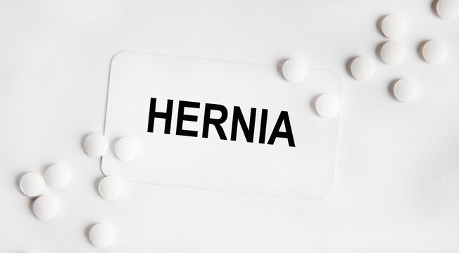 HERNIA - the inscription on the business card, next neatly laid out tablets.