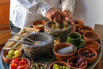 Chef preparing a traditional Pasilla Chile Sauce with all the ingredients in Oaxaca, Mexico. Focus...