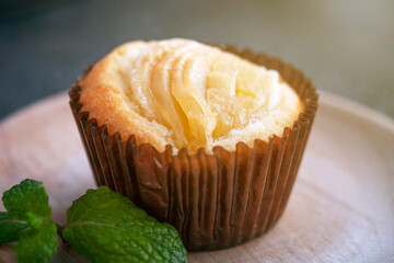 Rice flour cupcake with apple slices. The cupcake lies on a wooden plate. Apple filling..Delicious homemade cupcake. Baking for tea and a cafe.