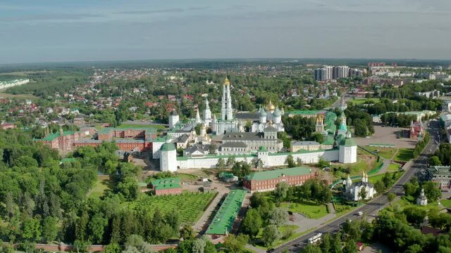 Scenic cinematic aerial view of Trinity Lavra of St. Sergius in Sergiyev Posad in Moscow oblast in Russian Federation. Beautiful summer sunny look of ancient orthodox monastery in old town