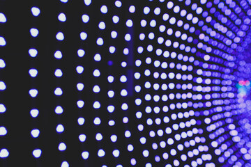 Abstract blurred purple bokeh on black background. Purple light from many bulbs at the festival.