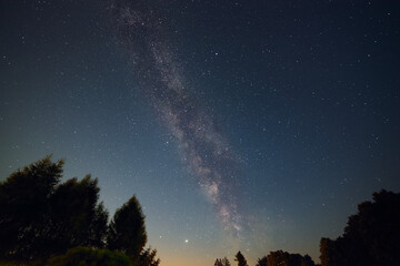 Milky Way on a summer night in Poland. Jupiter with its moons, and Saturn are visible in the lower part of the sky.