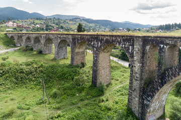 Fototapeta na wymiar Aerial view of railway viaduct in Vorokhta village, Carpathians mountains, Ukraine