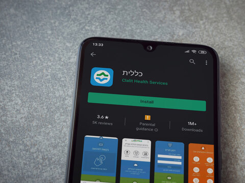 Lod, Israel - July 8, 2020: Clalit Health Services App Play Store Page On The Display Of A Black Mobile Smartphone On Ceramic Stone Background. Top View Flat Lay With Copy Space.