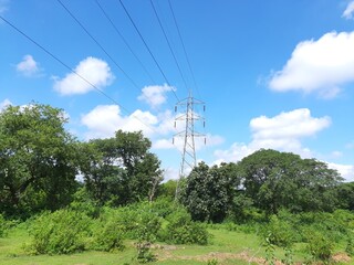 Obraz premium Electricity Tower. High voltage post or High voltage tower. View of fields with high-voltage transmission lines and electricity Towers. high voltage post. High-voltage tower sky background.