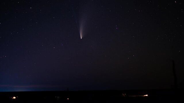 night sky with stars and neowise comet over the camp