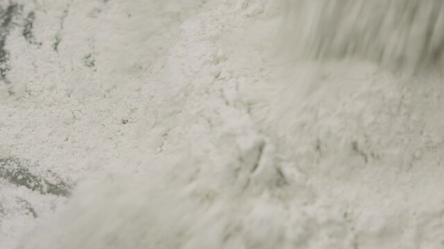 Slow motion adding hardener to micro concrete plaster