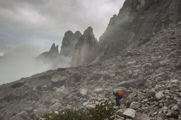 On trail #554 in dense fog before the last stretch to Rifugio Bruto Carestiato, beneath Pala del Belia mountain, Moiazza group, Alta Via 1 trek stage 10, Zoldo Dolomites, Belluno, South Tirol, Italy.