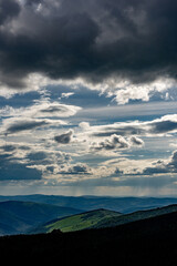 clouds over a wide hill landscape